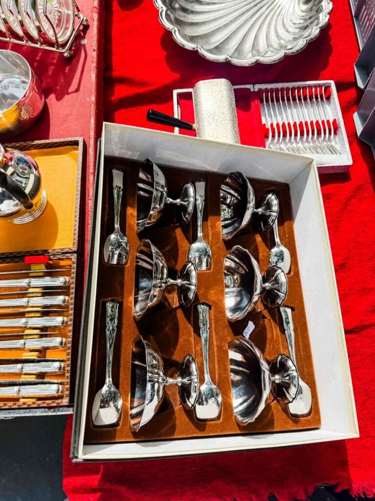 Vintage stainless steel desert cups and silver-plated spoons are in their original box.