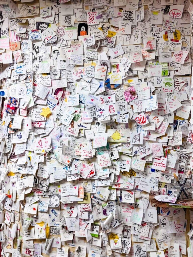 One solid wall is filled with notes and sketches from people all over the world that have visited the Sennelier Art Shop.