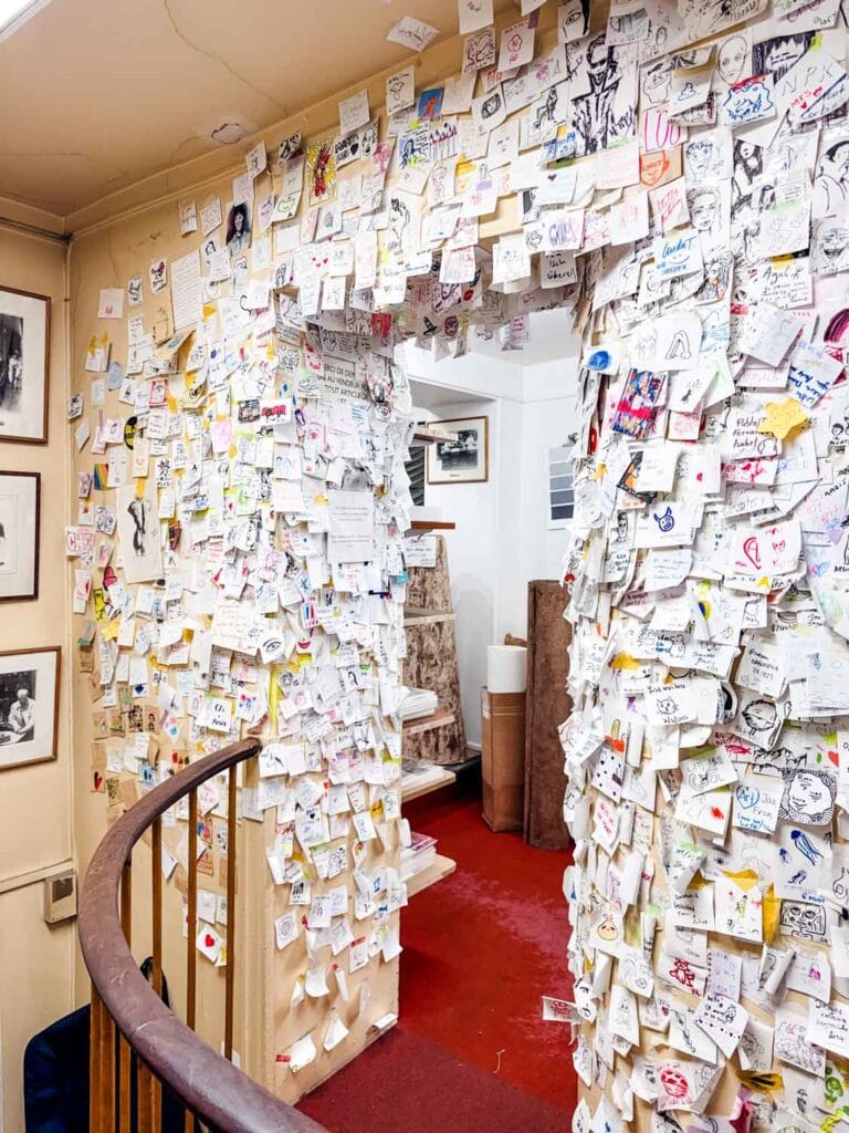 The wall of a thousand strangers is at the top of the stairs and hundreds upon hundreds of visitors have left notes and sketches over the years.