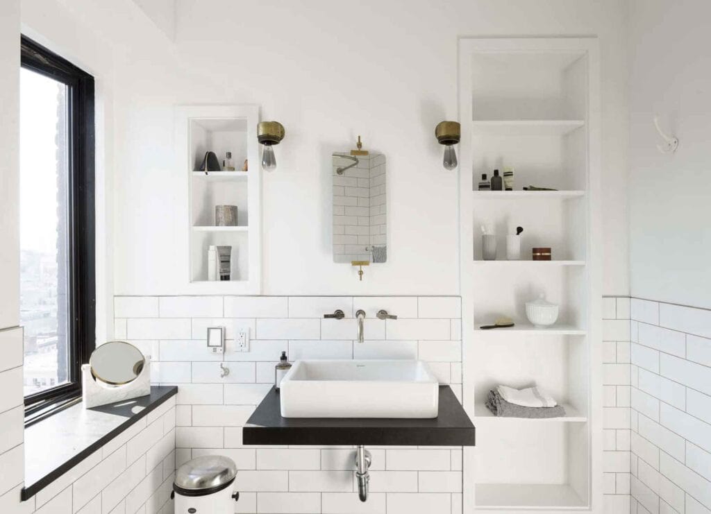 Black and white bathroom with a window, modern sink.