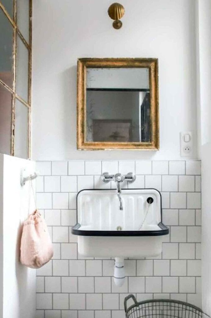 Utility sink, vintage gold mirror, sconce.