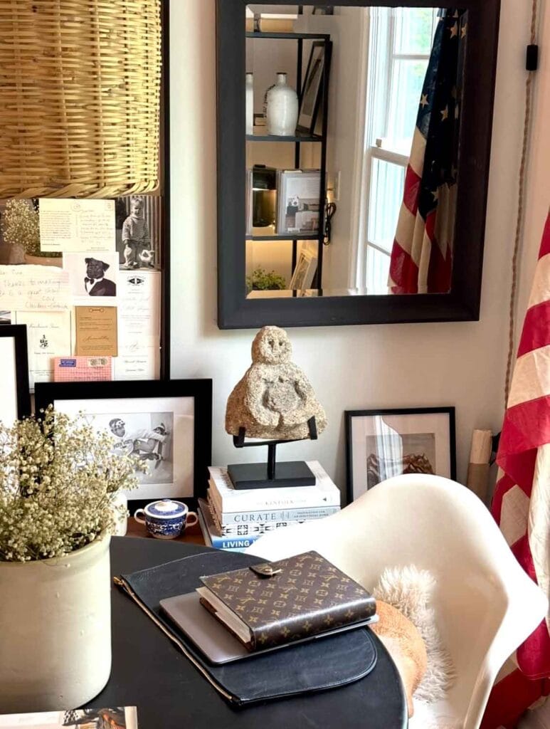 Wicker pendant, modern chair, leather agenda, crock, books.