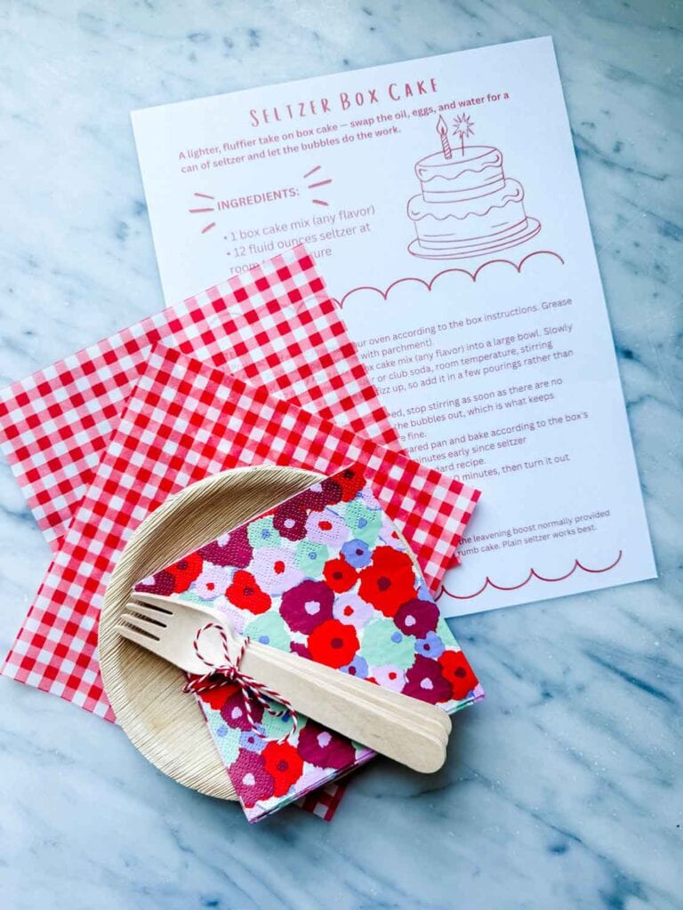 Some birthday cake kits include a recipe card, recyclable plates and wooden forks, and some napkins.