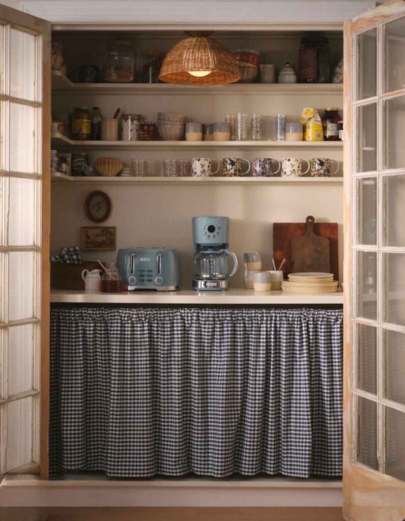 Cafe curtain in a pantry with open shelving.