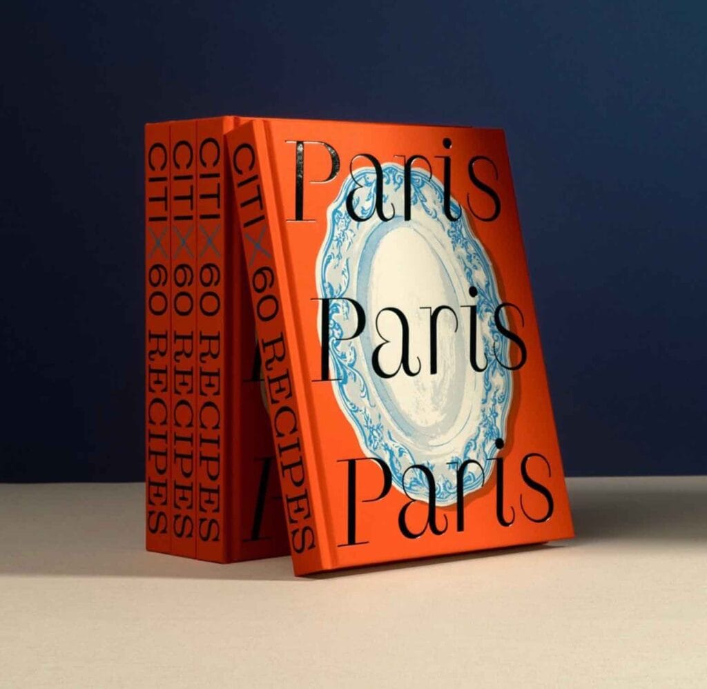 Paris Paris Paris cookbook on blue background.