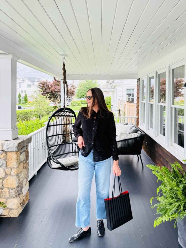 Annie Diamond wearing black short from Sezane, jeans from ALex Mill, Mansur Gavriel pleated tote.