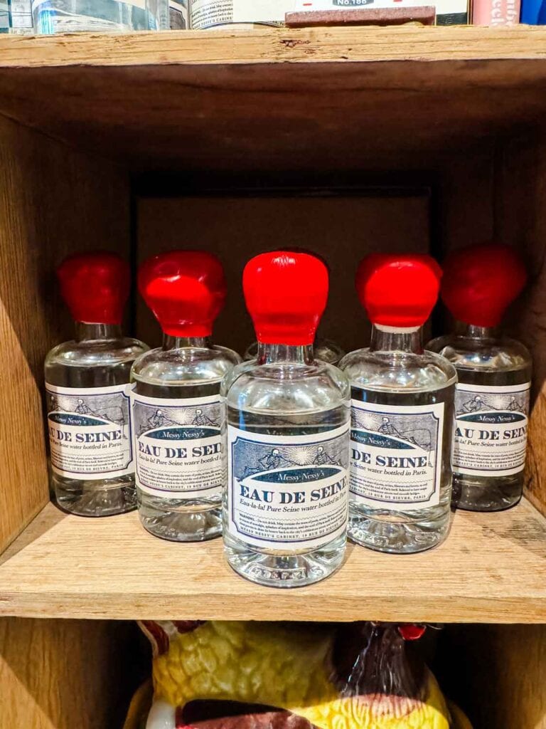 Water from the river Seine is bottle in vintage-like apothecary bottles and is for sale on the shelves inside Messy Nessy's Cabinet in Paris.