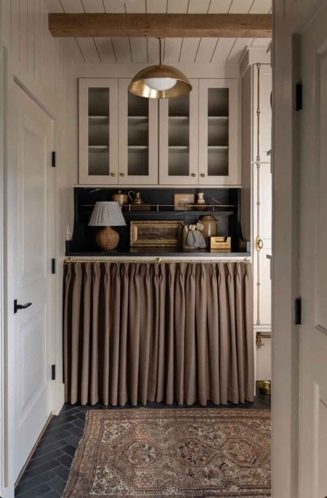 Cafe curtain covering washer and dryer.
