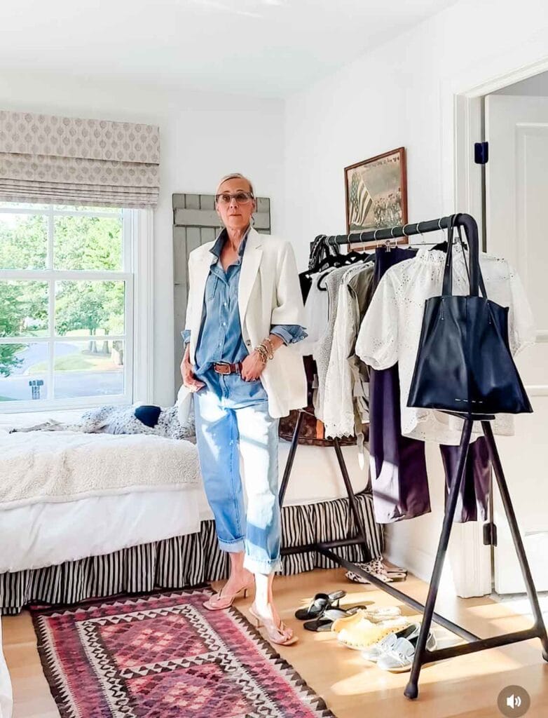 Tina Thompson in her guest rom wearing denim, white blazer.