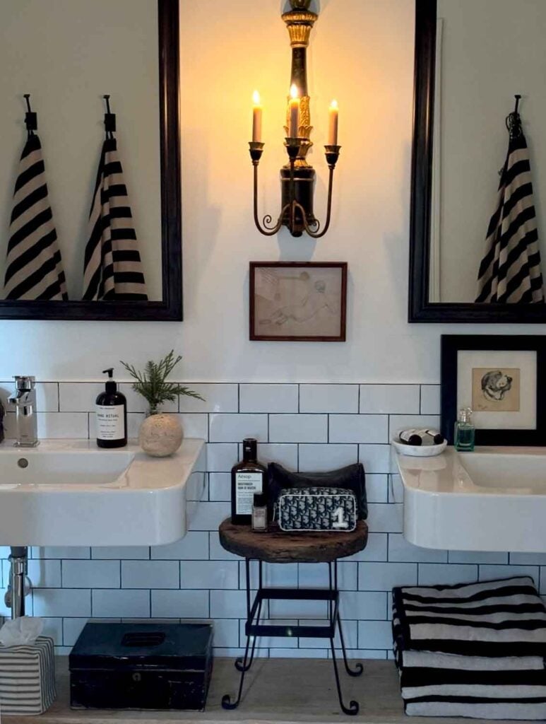 Bathroom vintage style, subway tile, striped towels, stool.