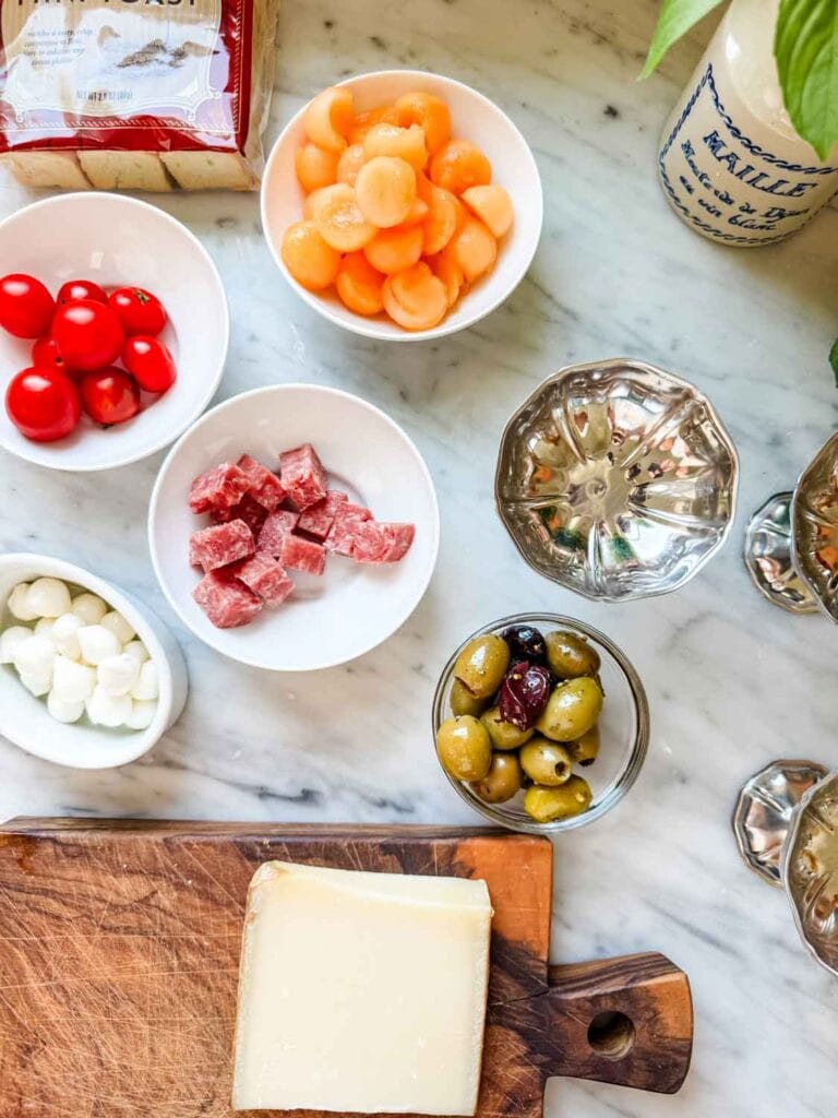 Charcuterie in small dishes with package of mini toasts.