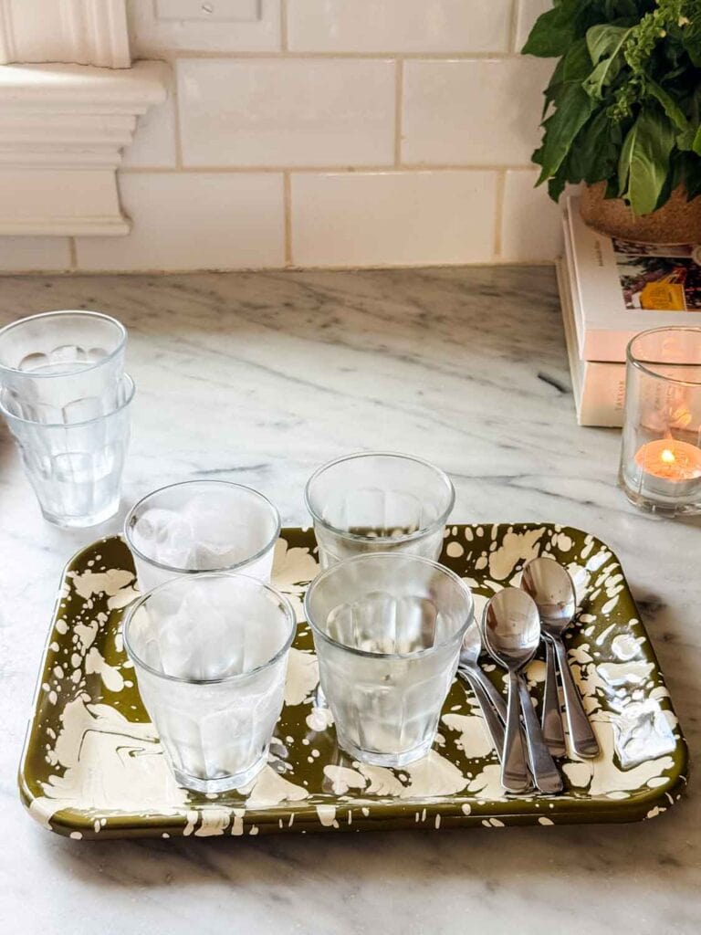 Small Duralex chilled glasses on green marbled tray.
