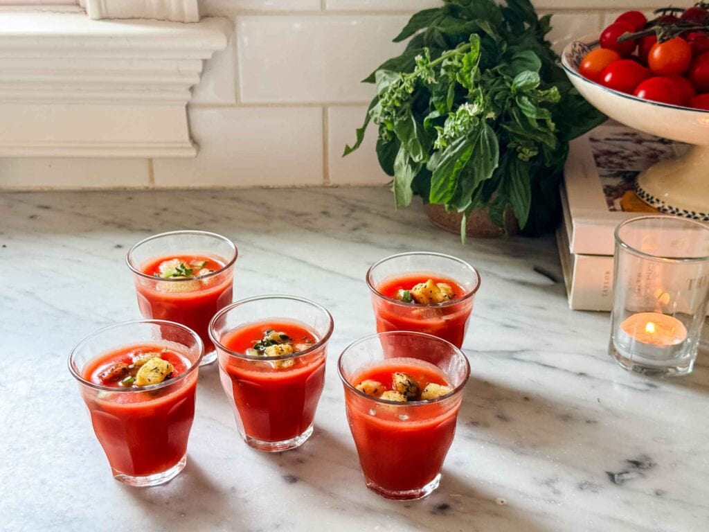 Ripe heirloom tomatoes and a kick of jalapeño in this beautifully smooth, strained gazpacho. Finished with fresh basil, flaky sea salt, and a drizzle of good olive oil in small Picarde chilled cups.