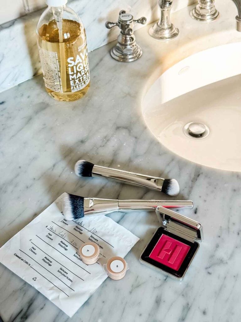 A photo of Haus Labs triclone skin tech foundation sitting on a bathroom counter.