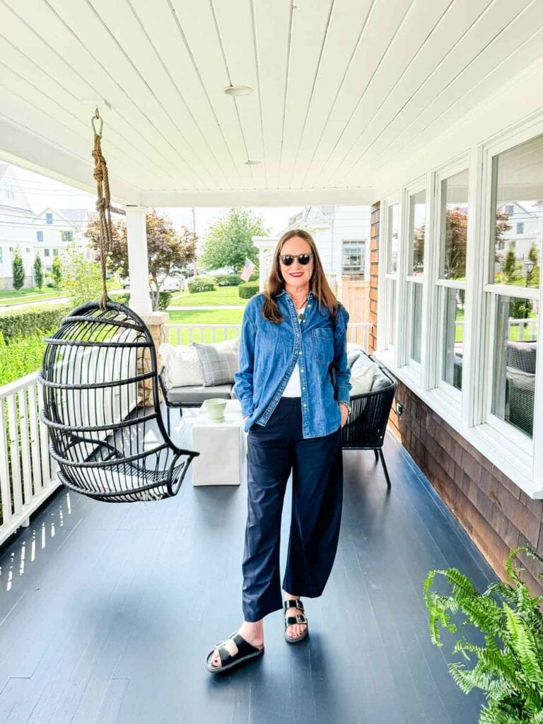 A woman modeling Ruti pants with a denim shirt.