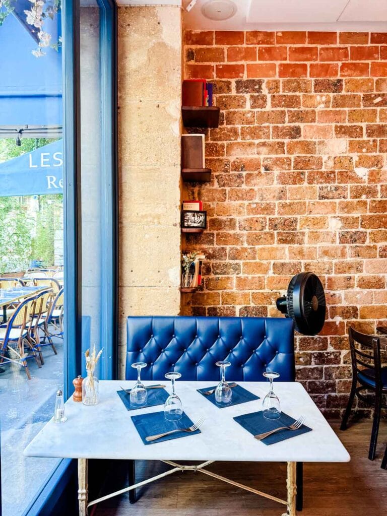 A cozy table in the window at Les Rupins in Paris.