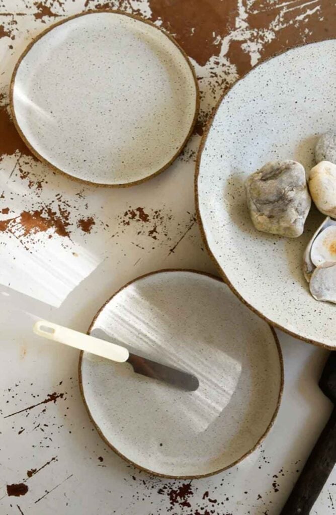 Small plates, bowls on rustic table top. 