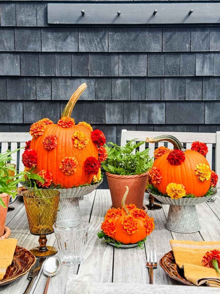 A tablescape with polka-dot pumpkins on galvanized cake stands.