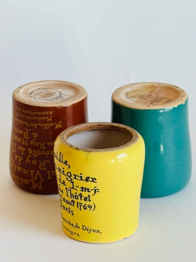 Three vintage mustard jars.