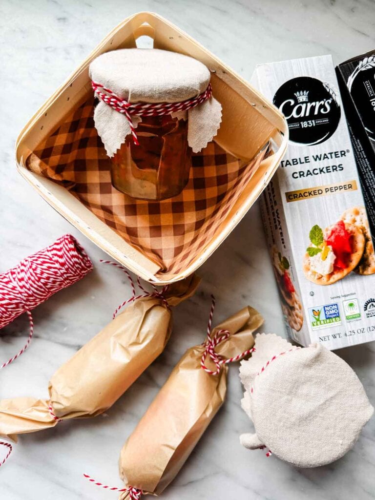 Wooden berry crates, goat cheese, jars with fabric jar toppers tioed up with twine, boxes of Carr's crackers.