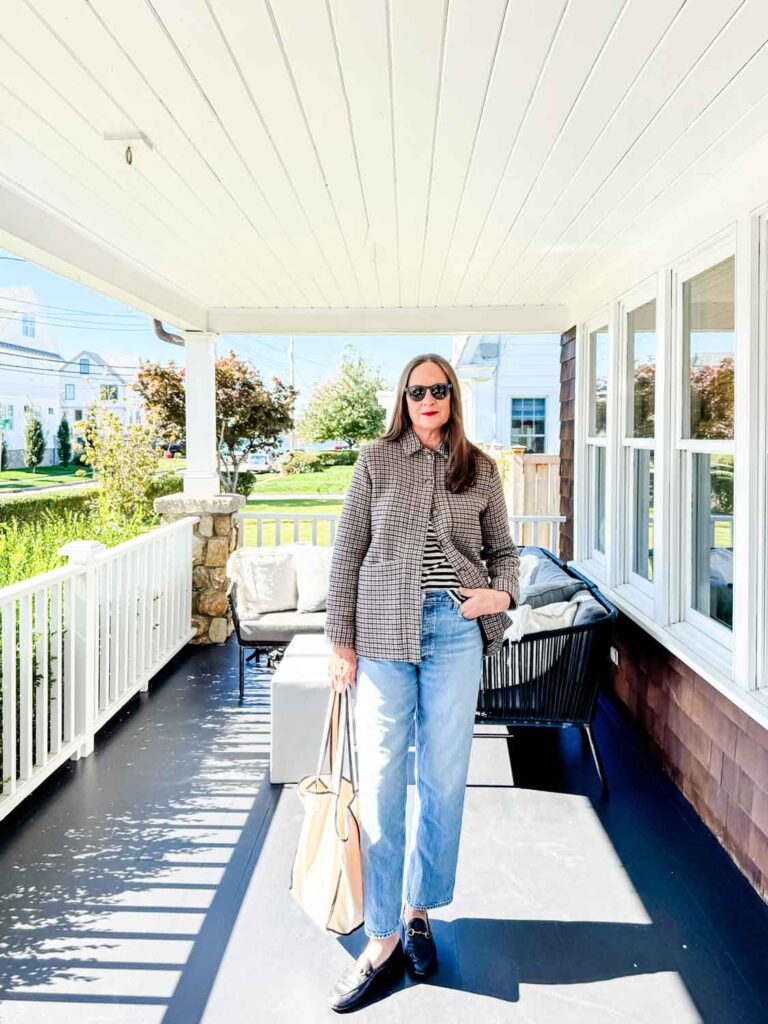 Annie Diamond weraing the Sézane Will houndstooth jacket with jeans.